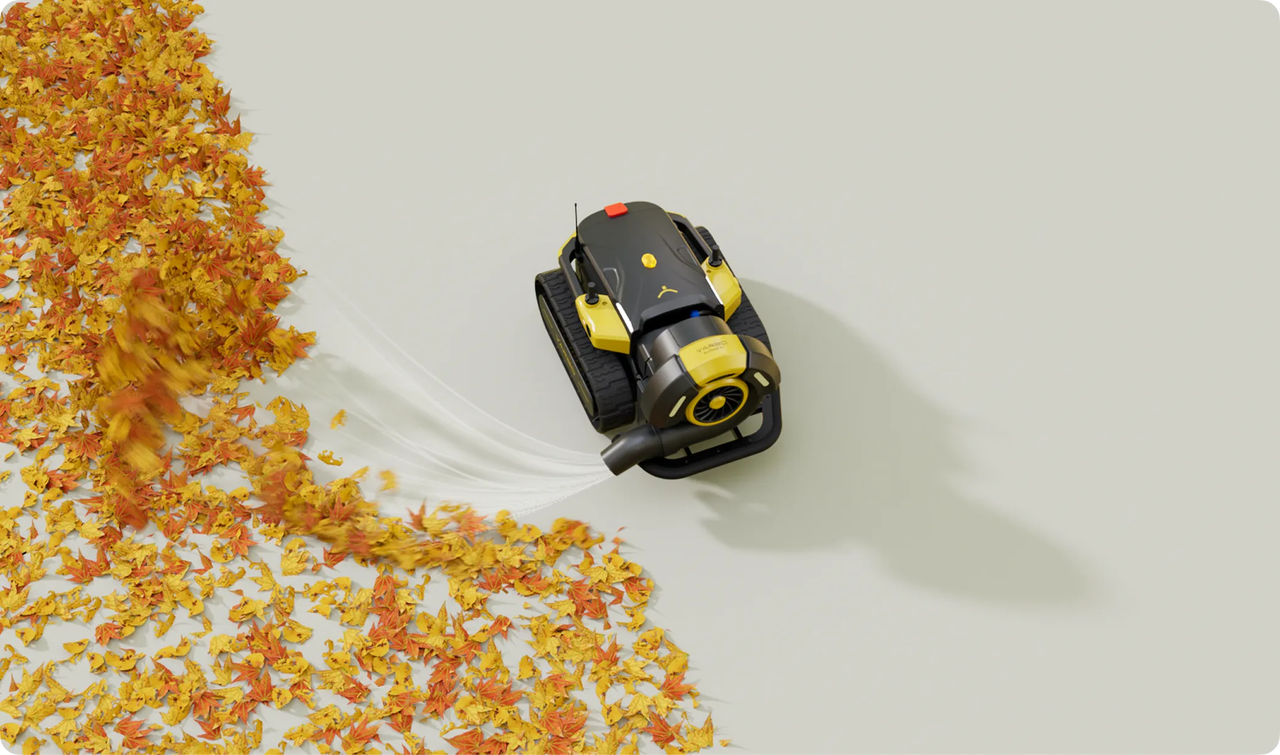 Yellow and black Yarbo robot blower efficiently sweeps vibrant autumn leaves across a clean, minimalist surface.