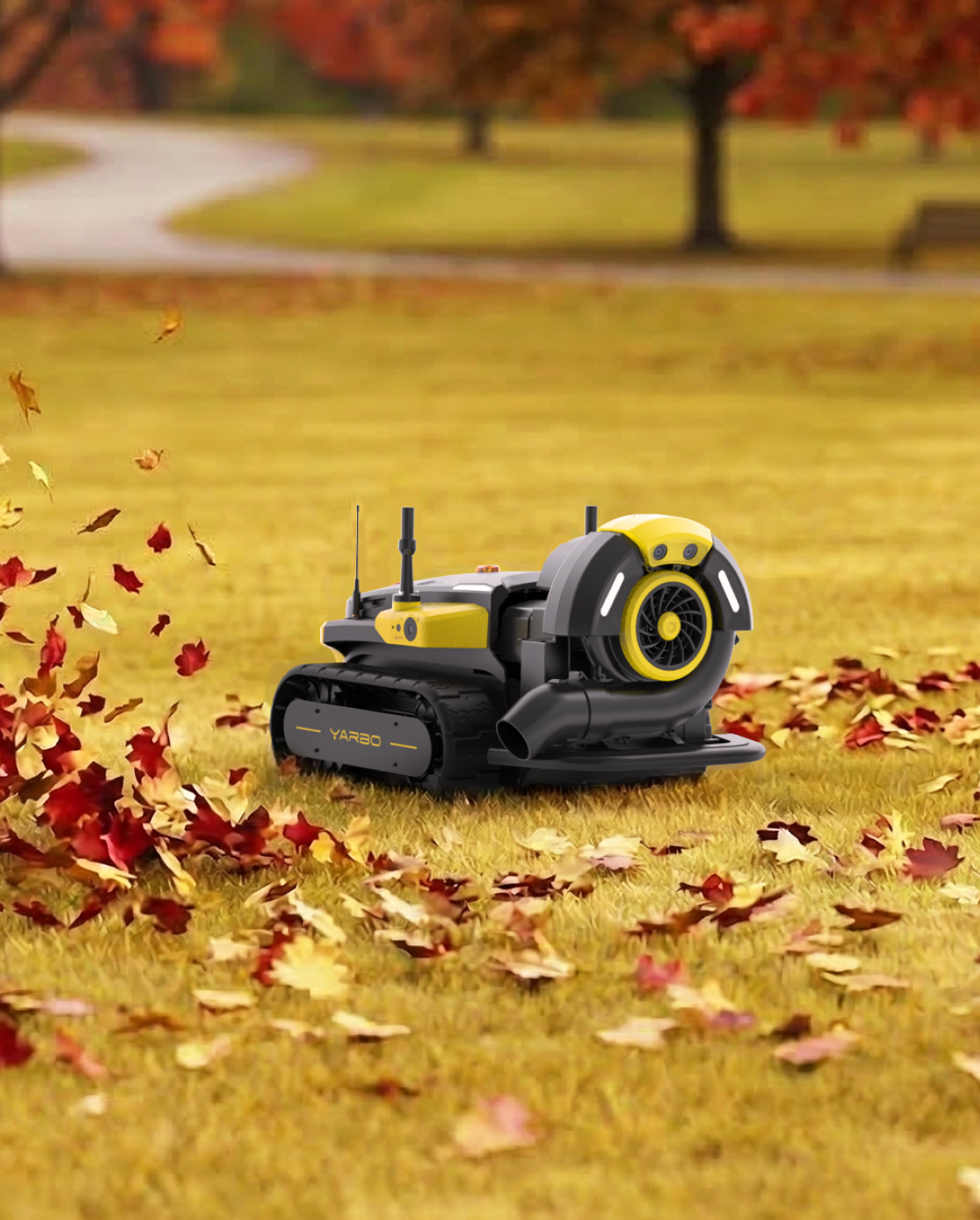 Black and yellow robotic lawn mower by Yarbo with tank treads and blower attachment, on grass with fallen autumn leaves, side view