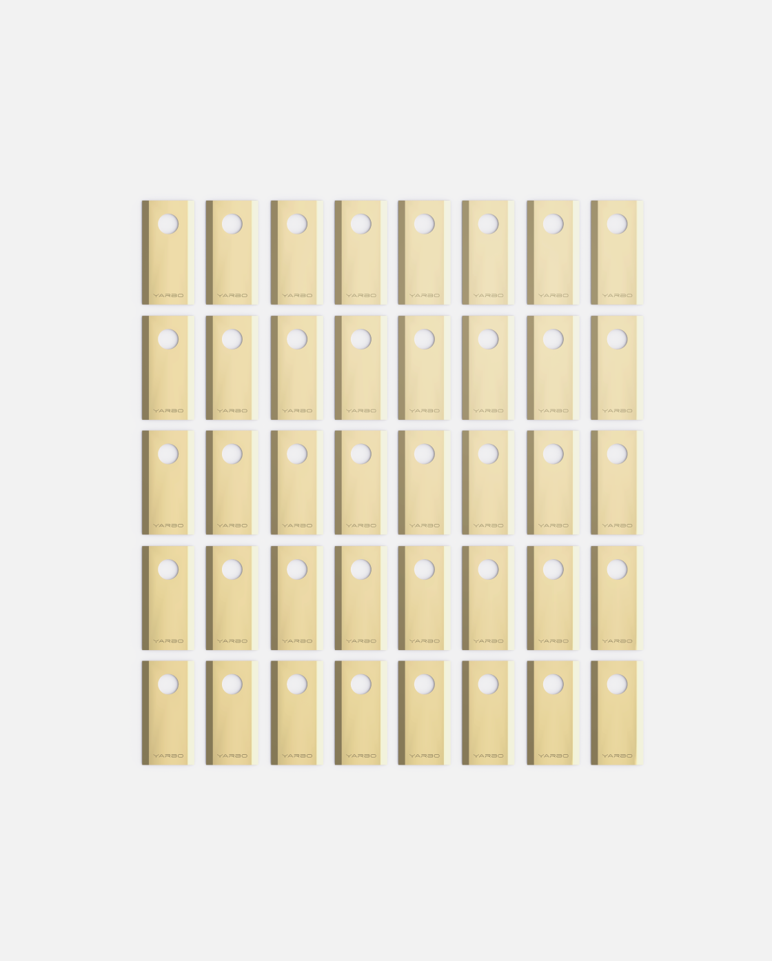 40-piece set of beige YARBO cutting blades with circular holes, arranged in grid, Y Series design, flat lay view