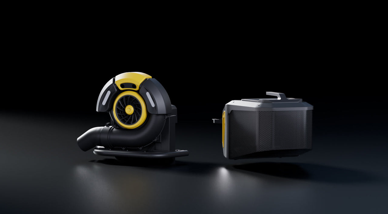Two black and yellow industrial vacuum components on dark surface, one with fan, one with perforated side, under spotlight.