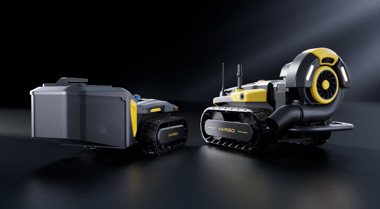 Two black and yellow YARBO tracked robots on dark surface, one with large fan, one with perforated box, studio lighting.