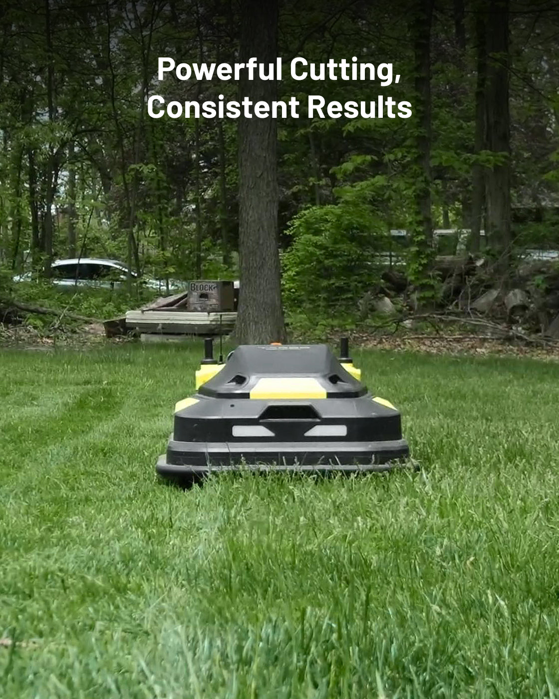 Black and yellow robotic lawn mower by Yarbo on green grass, front view, outdoor setting