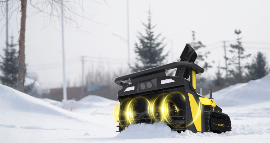 Yellow and black robotic snow blower with glowing lights clearing snow in a wintry outdoor scene.