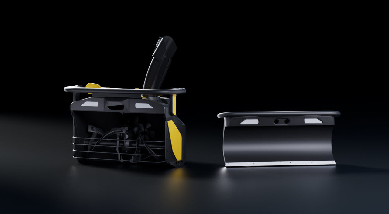 Black and yellow snow blower with detachable plow attachment on dark reflective surface.