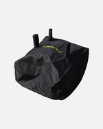Black protective cover with yellow logo and three top handles, by YARD, shown in angled view with visible stitching and textured fabric.