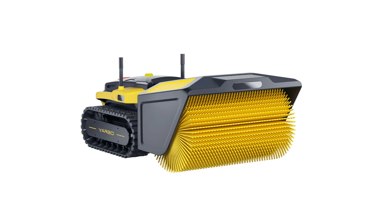 Yellow and black YARBO robotic sweeper with tank treads and wide bristle brush, isolated on white.